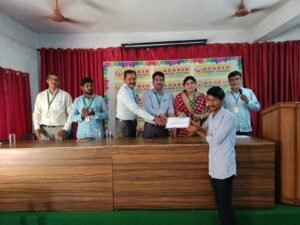 Student receiving live banking training certificate from Coursync during ceremony at Adarsh College Visakhapatnam.